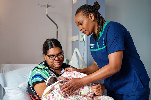 Midwife with new mum and baby