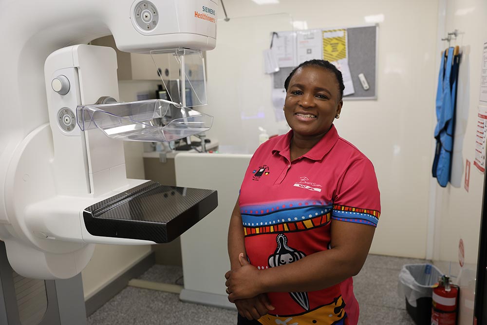 BreastScreen Nurse with a mamogram machine